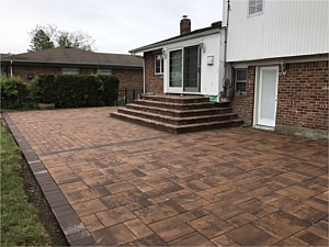 golden brown nicolock alpine contemporary smooth modern patio brick pavers jericho u shape steps from sliding doors bullnose darker border
